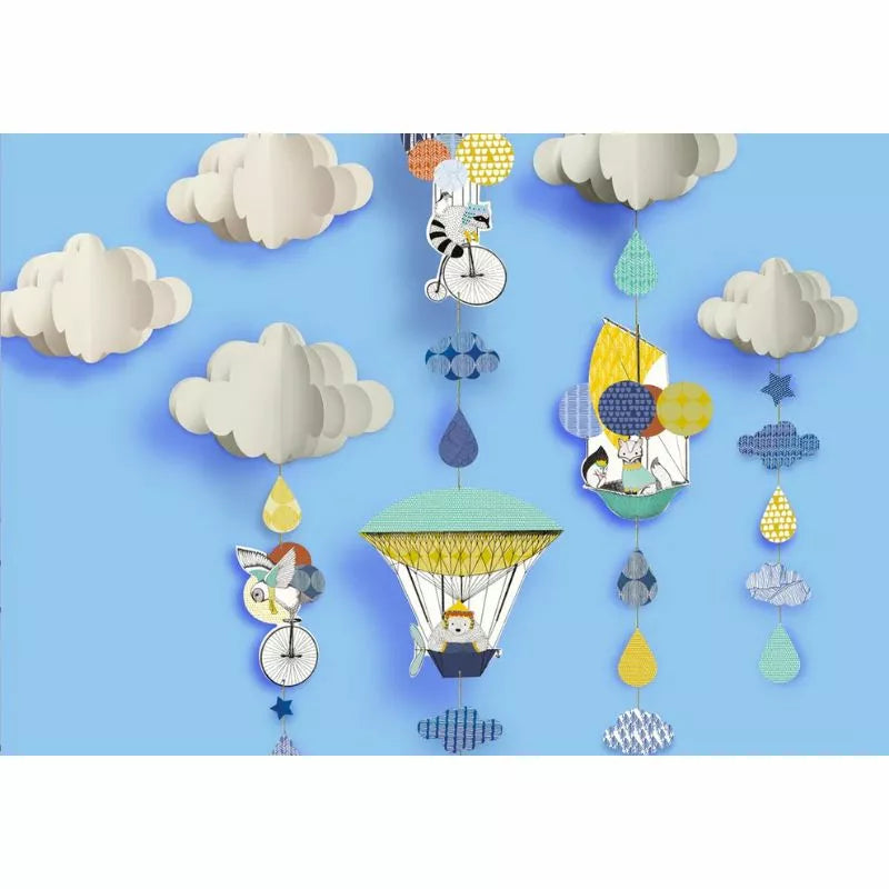A Creative Kit Polar Expedition of paper cut out clouds and balloons hanging on a blue background.