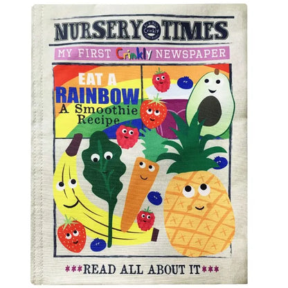 The "Crinkly Cloth Book Rainbow Smoothie" is a colorful baby book featuring smiling fruits and veggies—banana, avocado, carrot, strawberry, and spinach—on the cover with the headline "Eat a Rainbow." A delightful sensory cloth book for children!.