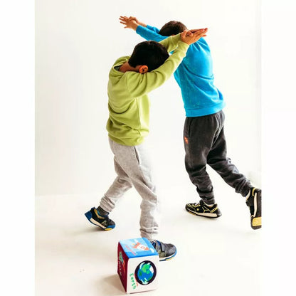 Two boys are having fun with a CubeFun Space, engaging in physical activity as they play with cubes.
