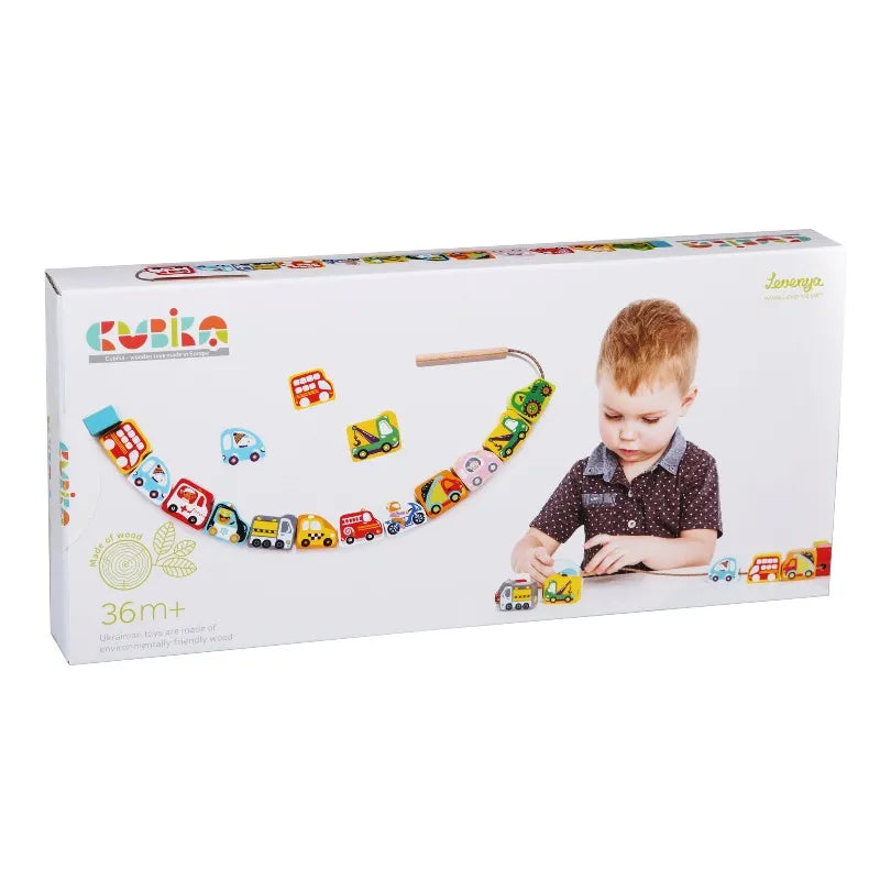 Box of Wooden Lacing Toy Flying Cars showcasing a young child playing with vibrant wooden vehicles, including cars, buses, and trucks. Recommended for children aged 36 months and older. The vehicles are connected with a string and adorned with colorful beads to help develop fine motor skills.