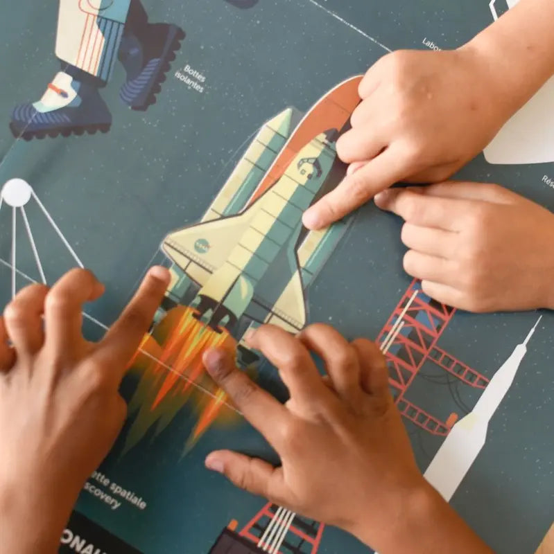 Three children's hands touch an illustrated space shuttle launching on the colorful Poppik Discovery Sticker Poster – Astronomy, which features text, images, and educational stickers about space exploration.