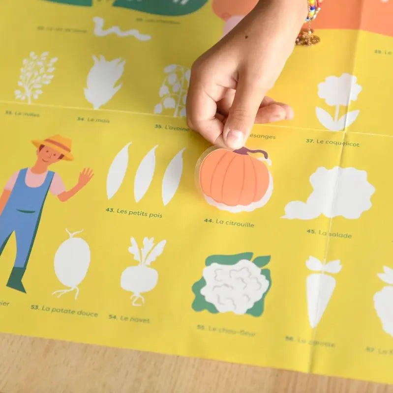 A child holds a pumpkin sticker above the Poppik Discovery Sticker Poster – Farm, a yellow bilingual activity poster in French with illustrations of a farmer and produce like peas, cauliflower, and radish.