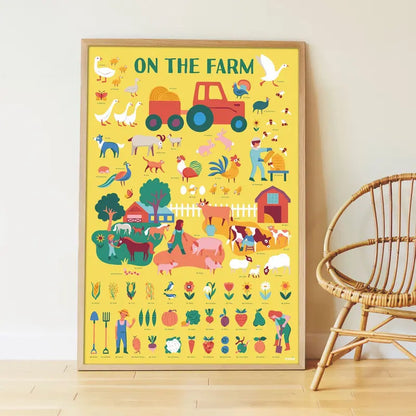 The Poppik Discovery Sticker Poster – Farm is a colorful bilingual activity poster featuring farm animals, a tractor, crops, and farmers, shown leaning against a wall beside a wicker chair on a wooden floor.
