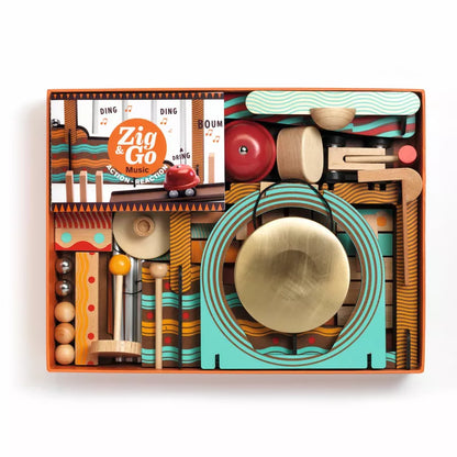 A Djeco Zig & Go Music wooden box filled with lots of different items.