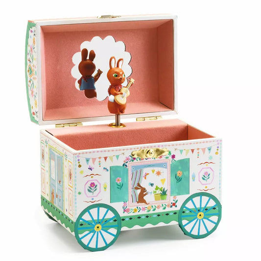 A Djeco Musical Boxes Enchanted Caravan with a bunny in it.