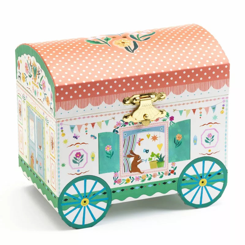 A small jewelry box with a Djeco Musical Boxes Enchanted Caravan on it.