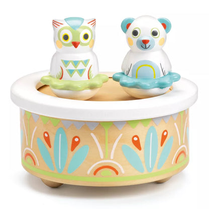 A Djeco box with a BabyMusic owl figurine sitting close by.