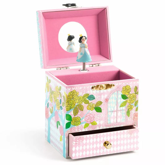 A pink Djeco Music Box Delighted Palace with a mirror inside of it.