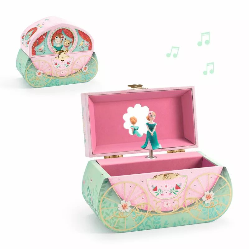 A pink and green Djeco box with a Musical Box Carriage ride figure inside of it.