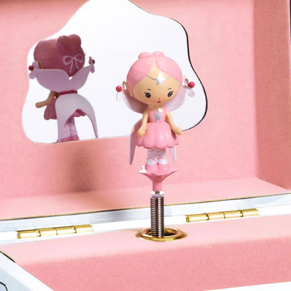 Inside the captivating Djeco Musical Box Elfe's Song, a charming pink ballerina figurine twirls gracefully on a spring. A mirror beautifully reflects her dance, making this jewelry box both elegant and functional. Its soft pink interior makes it an enchanting piece for storing jewelry.