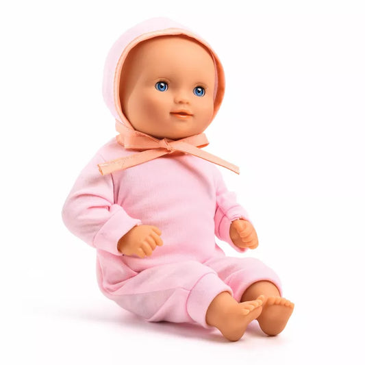 A Djeco Baby Lilas Rose Baby Doll with a pink outfit on.