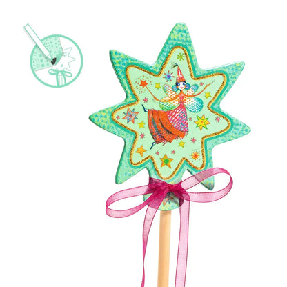 The Djeco Create Little Fairies is a vibrant, star-shaped magic wand featuring an enchanting illustration of a fairy in the center. The green star sparkles with glitter and is adorned with a pink bow around the wooden handle. An inset provides an extra close-up view of the fairy design, making it ideal for any children's activity or imaginative toy collection.