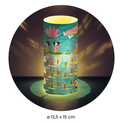 The Djeco Create Fireflies Dance is a cylindrical paper lantern featuring intricate cut-out designs and vibrant illustrations of flowers, a woman, and animals. It emits a warm glow that creates captivating patterns on the surrounding surfaces. The lantern measures 12.5 cm in diameter and 15 cm in height.