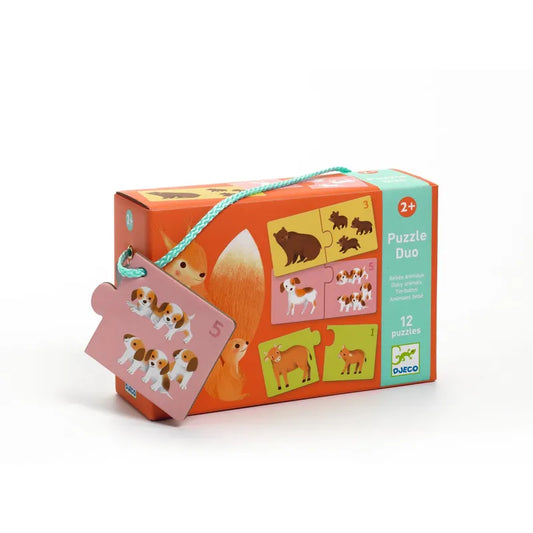 The Djeco Educational Puzzles Duo Baby Animals for ages 2+ comes in vibrant orange packaging with adorable animal illustrations, including a sample puzzle piece showing two dogs. It offers an engaging educational experience with 12 colorful matching games of baby animals like a bear and a dog.