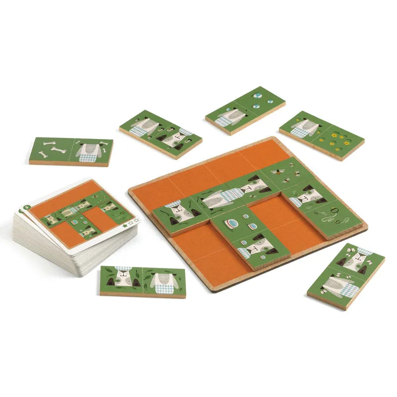 The Djeco Sologic Dogmino board game is arranged in a grid layout, showcasing challenge cards adorned with green and orange patterns that illustrate tools, animals, and plants. Certain cards are strategically placed on the game board, while others are scattered among wooden domino tiles.