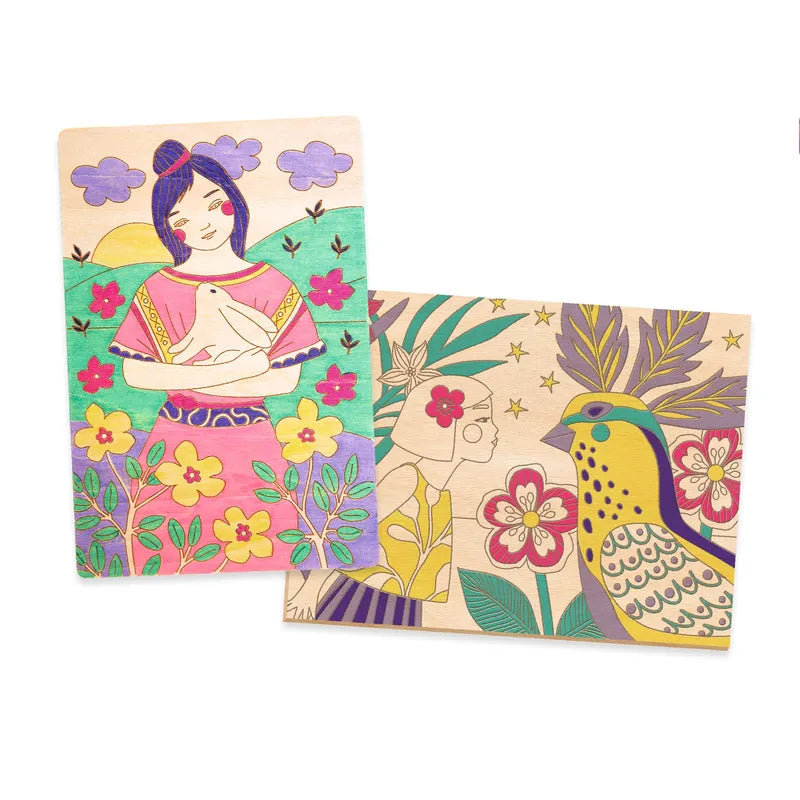 Two Djeco Drawing & Colouring Sweet girls with laser-engraved illustrations; one depicting a woman in traditional attire next to purple flowers, and the other featuring a large yellow bird among pink and red flowers.