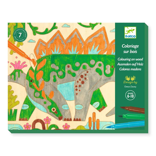 A Djeco Drawing & Colouring Dino world set for children featuring a wooden board with laser-engraved illustrations of a jungle scene, including a large elephant amongst green foliage. The packaging indicates it's suitable for ages 6-10.