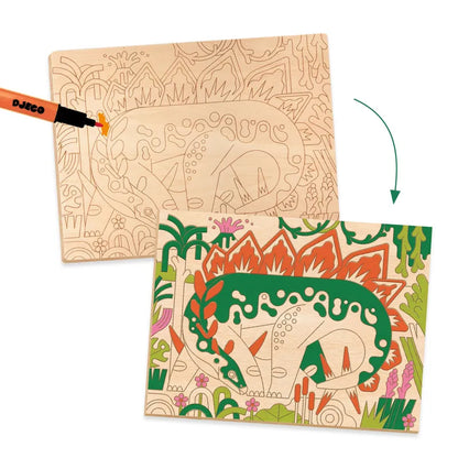 A Djeco Drawing & Colouring Dino World featuring two images: one with a pre-drawn jungle scene with a dinosaur, laser-engraved on wooden panels, and another showing the scene colored in with vibrant greens.