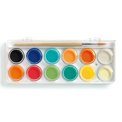 The Djeco Watercolours Palettes- 12 Colour Cakes - Classic includes a rectangular mixing palette with 12 circular color wells, featuring ultra-washable paint in black, dark blue, blue, teal, two shades of orange, dark red, red, green, yellow, and white; a wooden paintbrush rests on top of the open lid.