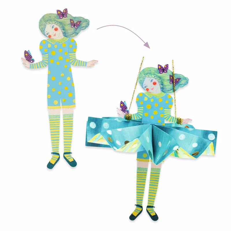 A Djeco Paper Creations paper doll with blue dresses and a butterfly.