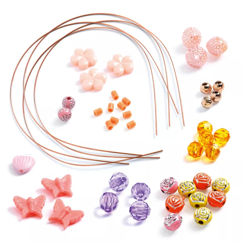 A bunch of Djeco Jewels to Create Precious beads in different colors on a white surface.