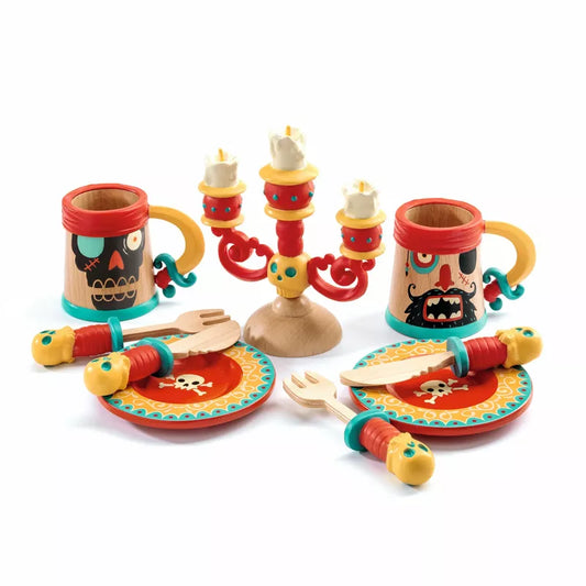 A wooden table set with Djeco Pirate Dishes, arranged for a candlelight meal.