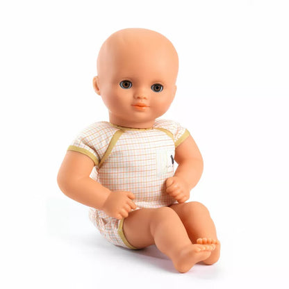 A Djeco Baby Praline Baby Doll sitting on a white background.