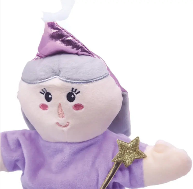 The Double-Face Hand Puppet Grandma-Fairy is a soft doll with gray hair, a purple hat and dress, holding a gold star wand. It has rosy cheeks, a small smile, embroidered eyes, and inspires creative play as both doll and puppet.