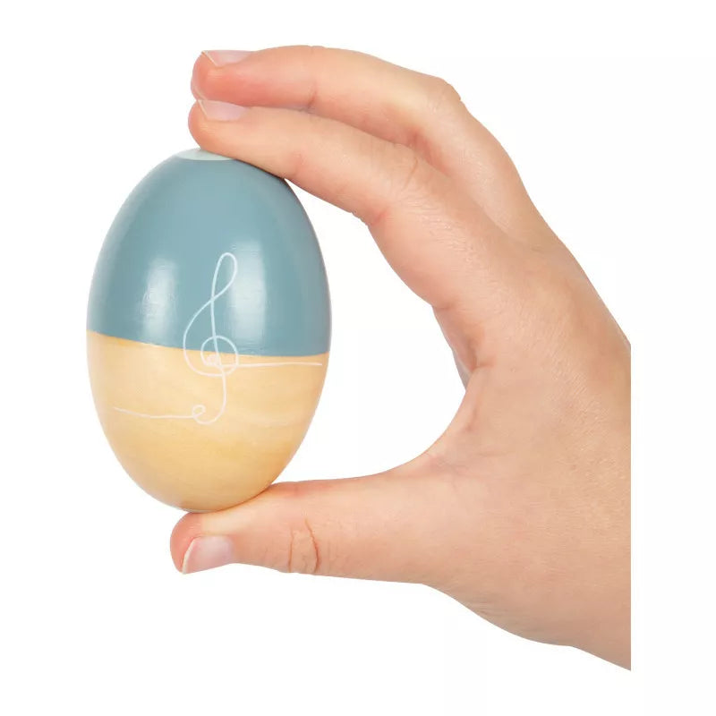 A hand holding a "Musical Eggs Groovy Beats" with a musical note painted on it.