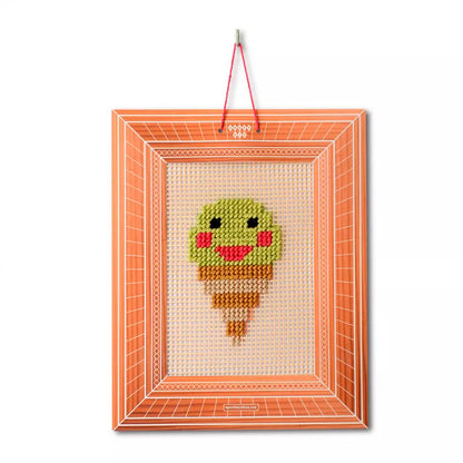 An Embroidery Kit Ice Cream picture hanging on a wall.