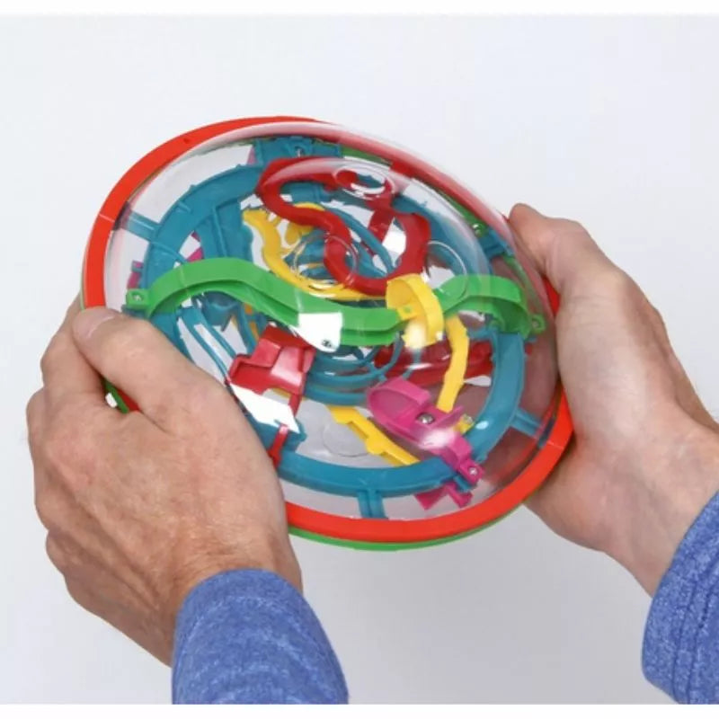 A person holding a Eureka 3D Puzzle Amaze UFO challenge with a lot of colorful pieces, testing their patience.