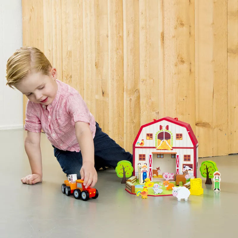 A little girl playing with the New Classic Toys Farm House Playset.