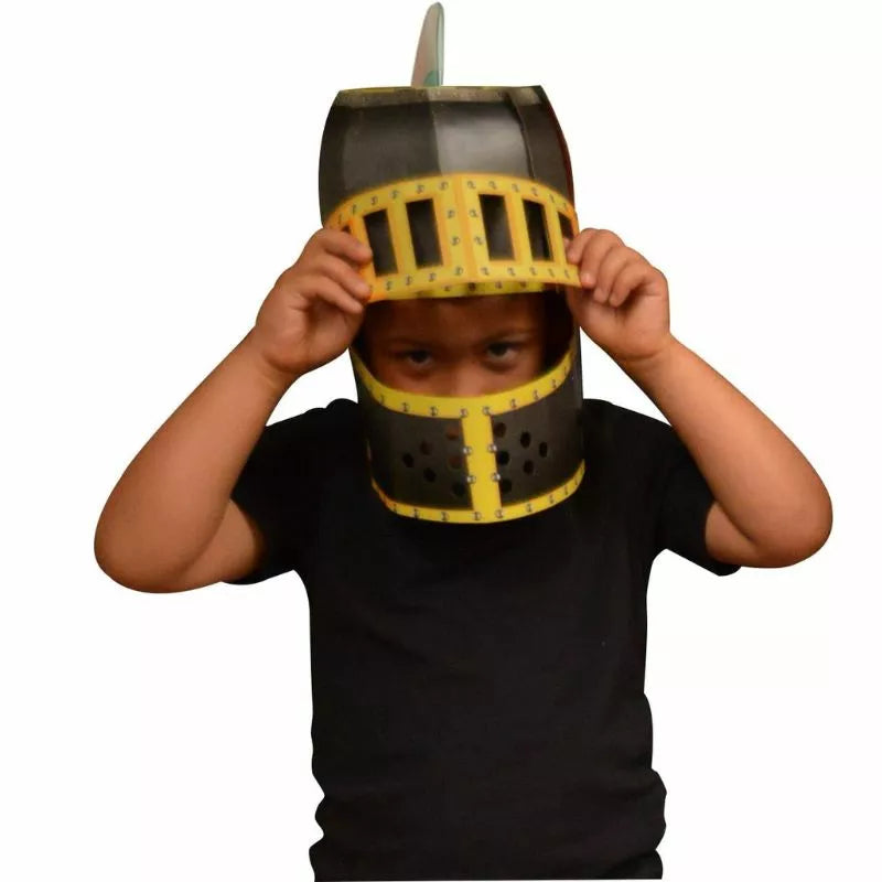 A young boy dressing up in a Fiesta Crafts 3D Mask Knight Helmet for arts & crafts.