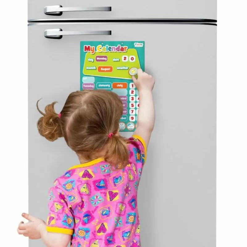 A little girl is pointing to the Fiesta Crafts Magnetic My Calendar on a refrigerator.