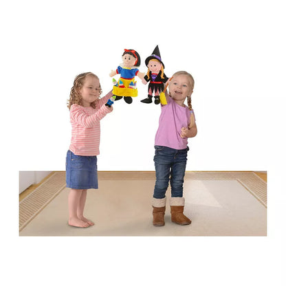 Two little girls standing next to a Fiesta Crafts Snow White Puppet Set.