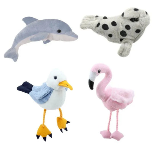 The Water Finger Puppets Pack of 4 features four plush toys displayed against a white background: a gray dolphin on the top left, a spotted gray seal on the top right, a white and blue seagull with yellow feet on the bottom left, and a pink flamingo with black feet on the bottom right. Ideal for exploring animal habitats.