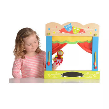 A little girl is playing with a Fiesta Crafts Carry Case Finger Puppet Theatre.