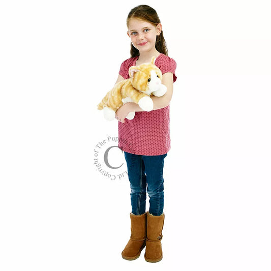 A little girl clutching The Puppet Company Full-bodied Hand Puppet Cat Ginger.