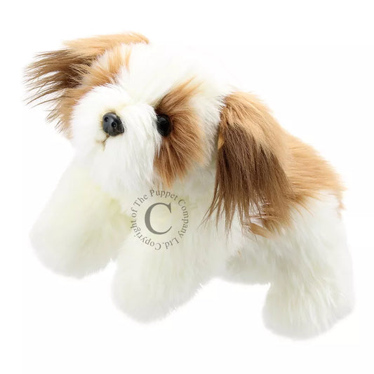 A small white and brown The Puppet Company Full-bodied Hand Puppet Dog is laying on a white background.