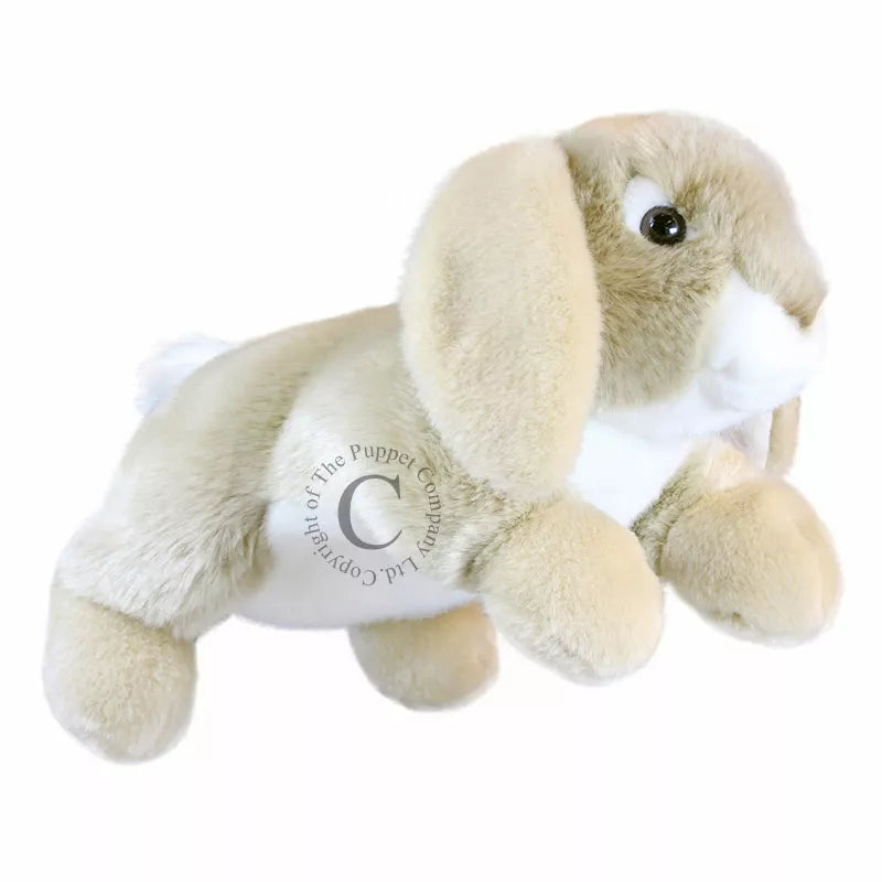 The Puppet Company Full-bodied Hand Puppet Rabbit, a soft toy, is whimsically soaring through the air against a crisp white background.