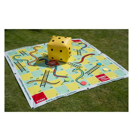 A yellow and green Garden Snakes & Ladders 2m board game laying on top of a green field.