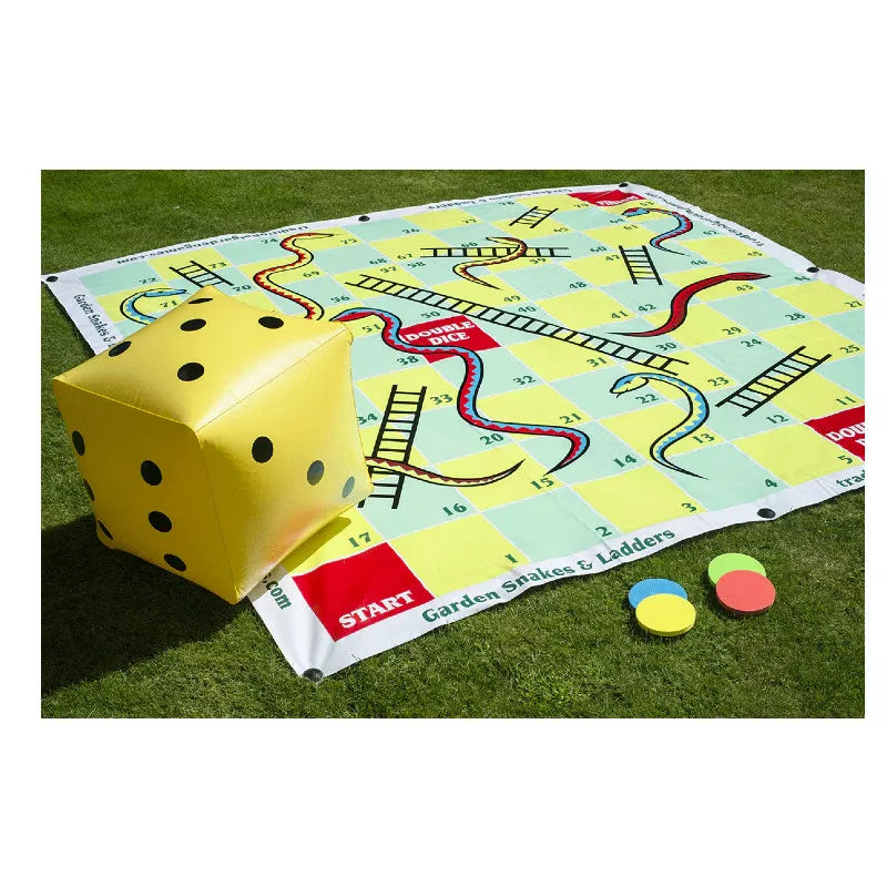 A yellow and black Garden Snakes & Ladders 2m game laying on top of a green field.