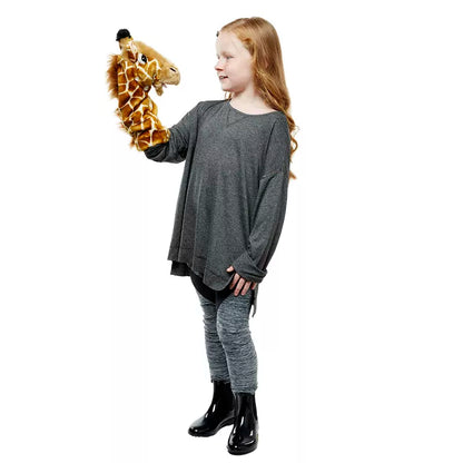 A girl holding the Puppet Company Long Sleeved Puppet Giraffe.