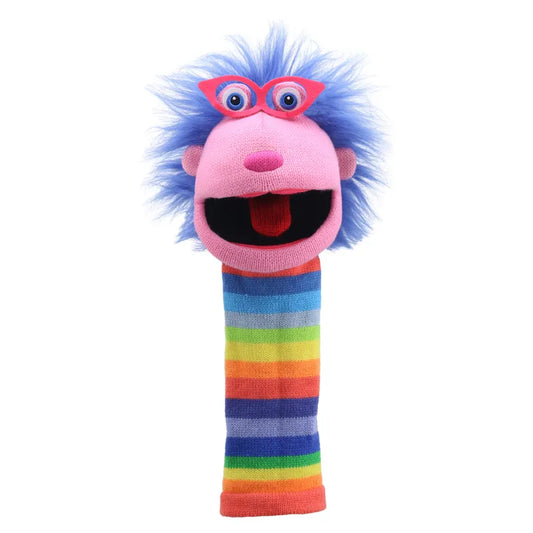 The Puppet Company Sockette Gloria is a vibrant puppet featuring a pink face, an open mouth, large blue eyes, pink glasses, and blue fuzzy hair. This knitted Sockette's body showcases horizontal rainbow stripes, adding to its colorful appearance.