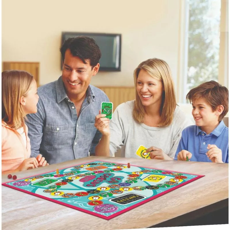 An educational family is playing the Go Genius Science Board Game at a table.