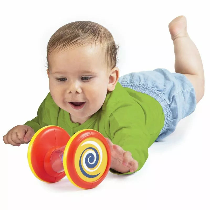A baby is laying on the ground with a Halilit Spinning Tubes.