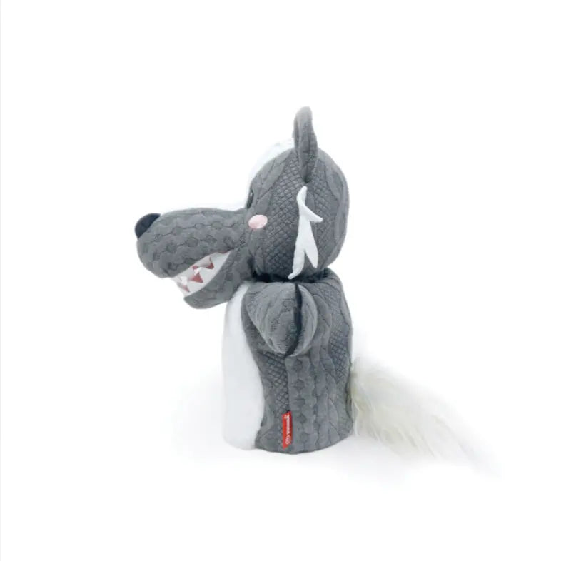 The Hand Puppet Wolf features gray and white textured fabric, a pink nose, white fangs, and a fluffy tail—ideal for storytelling or imaginative play—and is shown in profile against a plain white background.