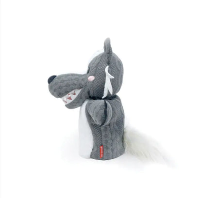 The Hand Puppet Wolf features gray and white textured fabric, a pink nose, white fangs, and a fluffy tail—ideal for storytelling or imaginative play—and is shown in profile against a plain white background.