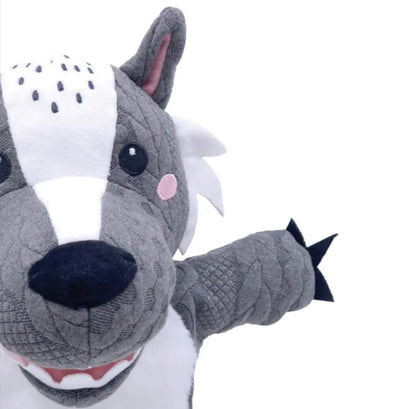 The Hand Puppet Wolf features gray and white fur, pink cheeks, black eyes, a large snout, and one raised arm. Perfect for imaginative play and storytelling, it's showcased against a white background.