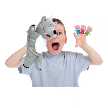 A young boy holding a Fiesta Crafts Big Bad Wolf & 3 Little Pigs Puppet Set over his head.